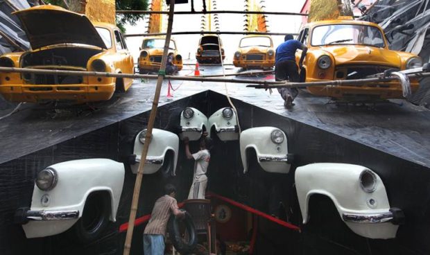 Farewell to yellow Taxi: The Iconic Yellow Taxi (Hindustan Motor ) is gradually fading away from Kolkata street now a days after. Hindustan Motors had suspended production from May 25, 2014 at his Uttarpara factory in West Bengal due to week demand and lack of funds.Like every years Beleghata 33 pally organised Duraga puja this year also theme of the puja is " Nostalgia" used .iconic ambassador more priciesly the yelow taxi. Organisers are using the ambassador car and parts of Ambassadors to decorate the pandal, bought 15 complete taxi , 200 silencer pipe ,300 gates of the car as well as other part of ambassaor.The artist of the Pandle is Shiv Sankar Das . Express photo by Partha Paul.27.09.16