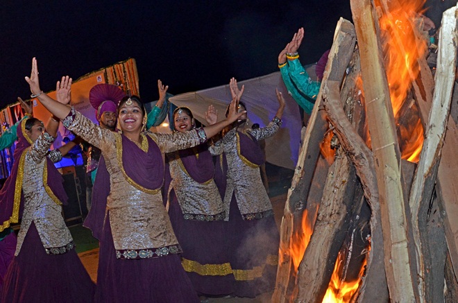 Girls in traditional outfits perform during Lohri celebration on the theme of say no to violence against women and girl child organised by Municipal Corporation, in Sector 40 of Chandigarh on Monday, January 13 2014. (Express photo by Kshitij Mohan)