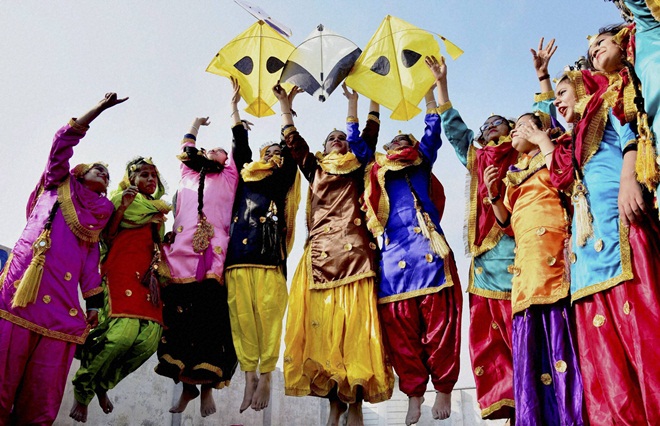 Amritsar: School girls wearing traditional Punjabi dresses perform at Lohri Festival in Amritsar on Thursday. (Photo Credit: PTI)