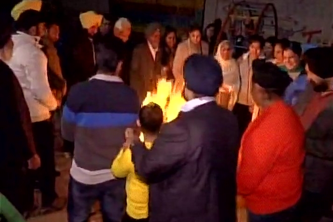 People gather around a bonfire in Ludhiana, indulge in Lohri festivities celebrating the onset of the harvest season. (ANI)