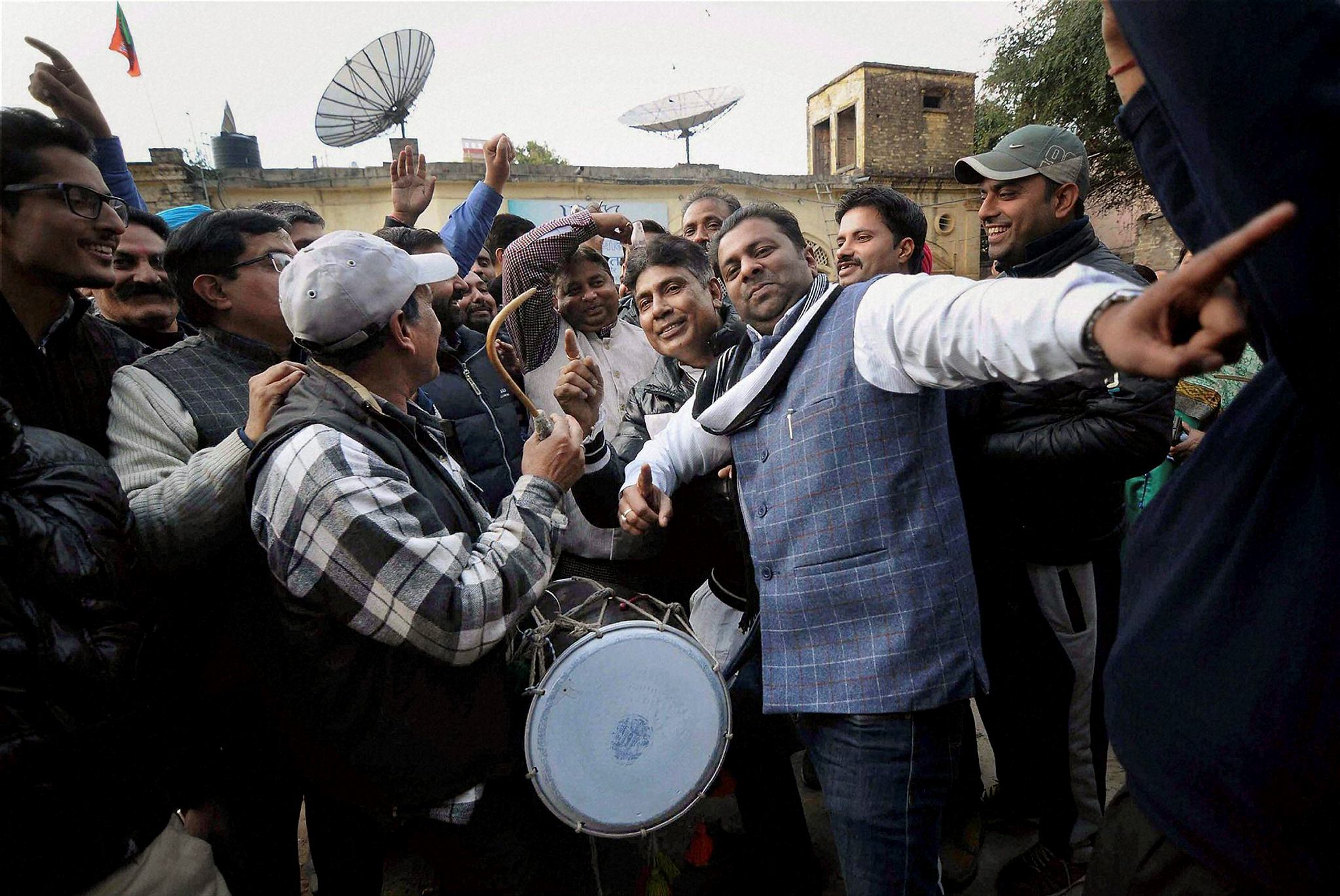 Bharatiya Janata Party leaders and party workers dance as they celebrate Lohri festival in Jammu on Friday. (PTI)