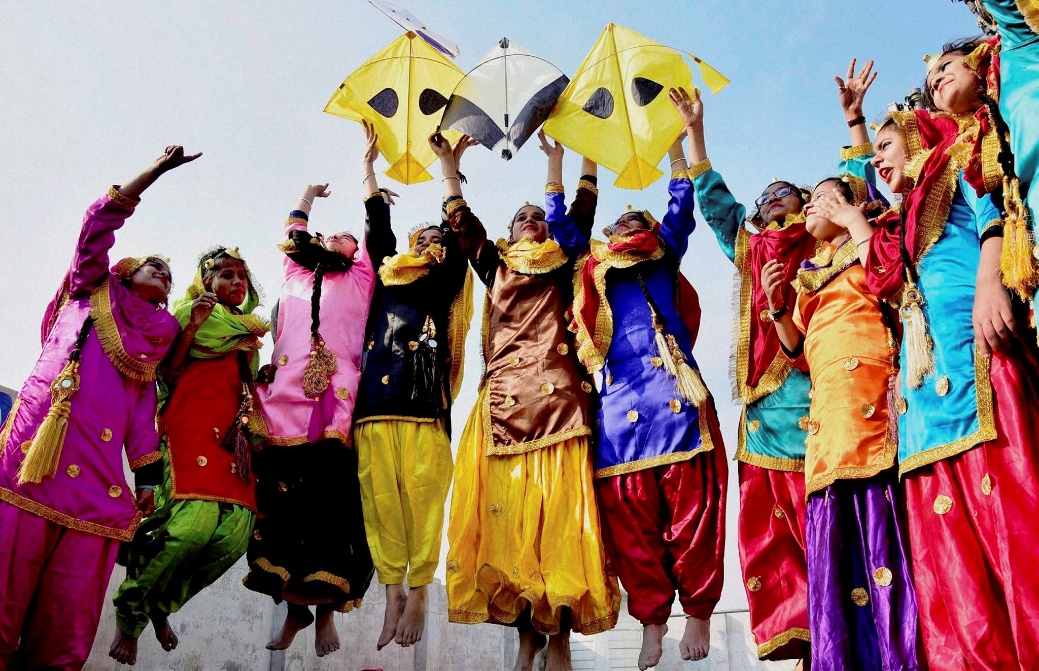 School girls wearing traditional Punjabi dresses perform at Lohri Festival in Amritsar on Thursday. (PTI)
