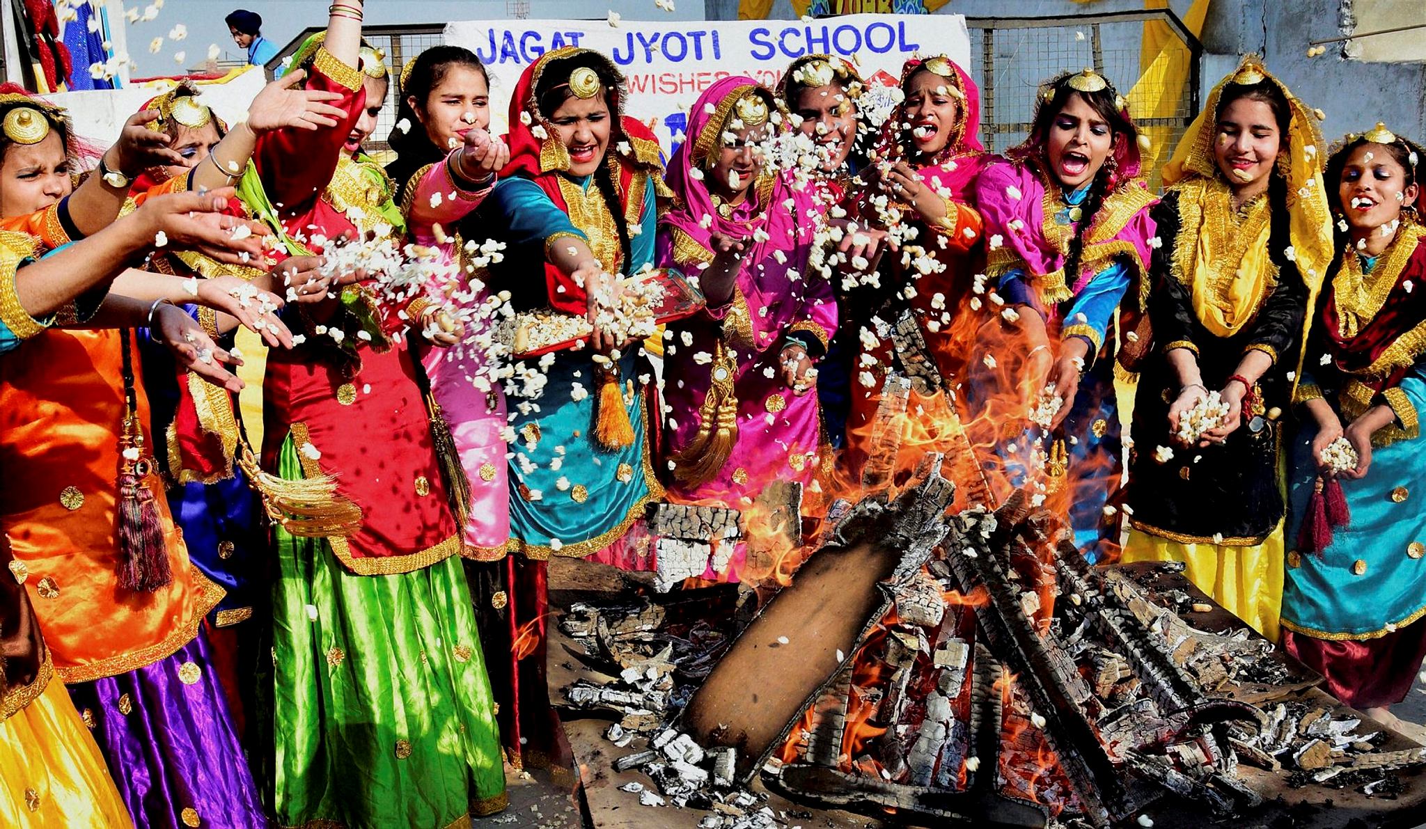 School girls wearing traditional Punjabi dresses perform at Lohri Festival in Amritsar on Thursday. (PTI)