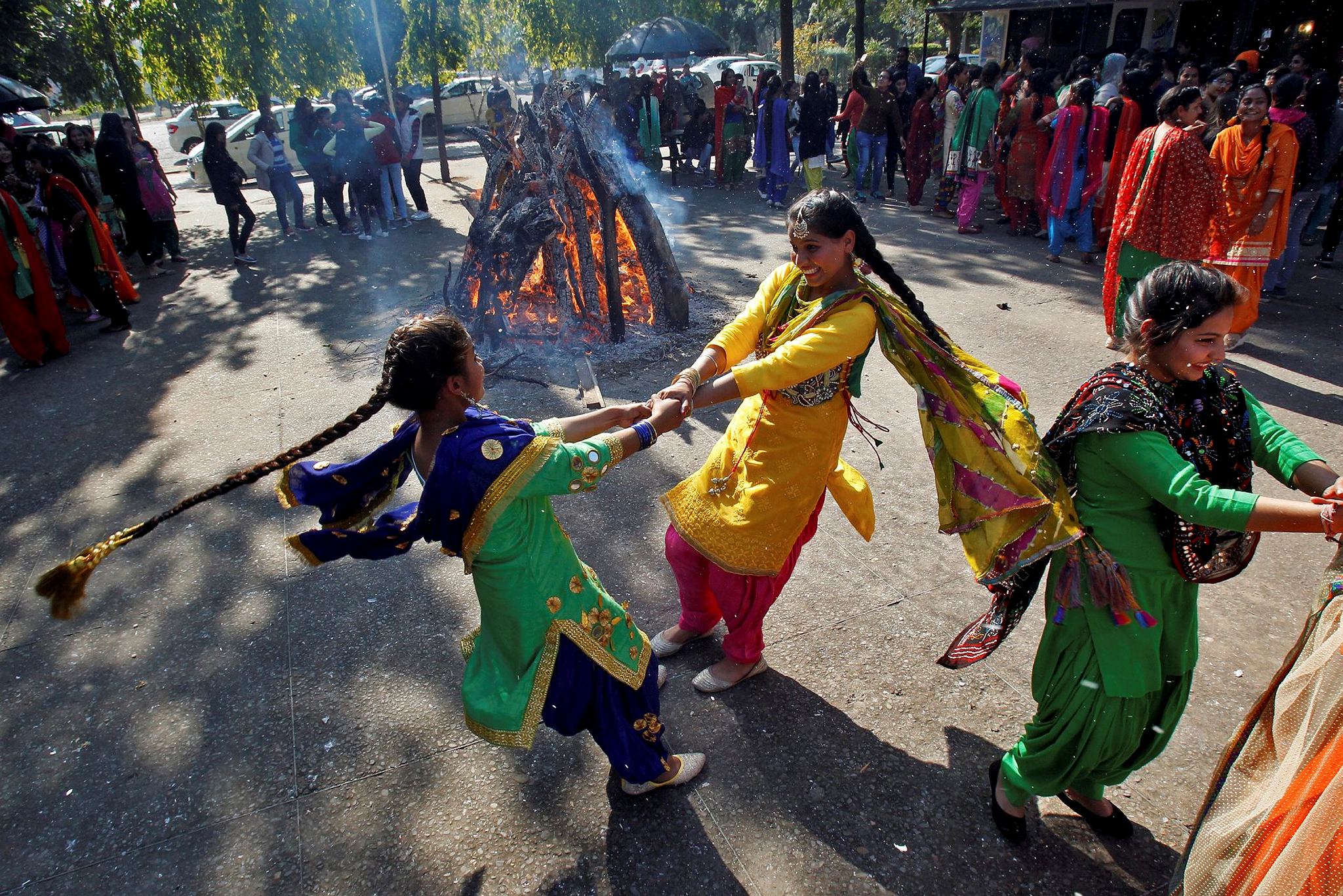 Students perform a traditional folk dance near a bonfire as they celebrate the Lohri festival, which marks the culmination of winter in many parts of northern India, inside a college in Chandigarh, India, January 13, 2017. (Reuters)