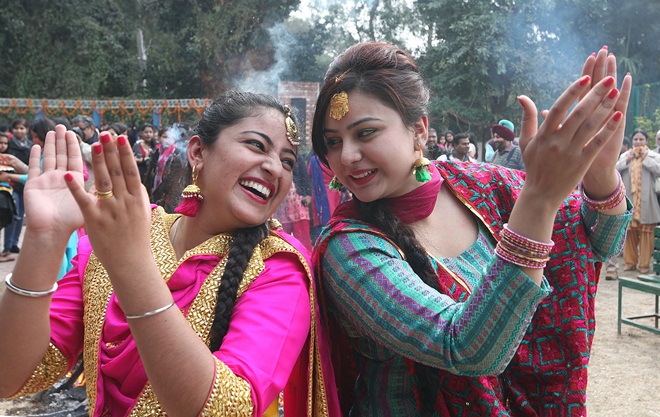 Students of MCM DAV College dancing and sharing sweets around bonfire to mark Lohri celebrations in Chandigarh on Saturday, January 12 2013. (Express photo by Jasbir Malhi)