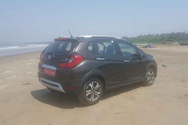 At the rear one finds angular tail lamps, which extend into the bootlid and here too there's a thick stripe of chrome.