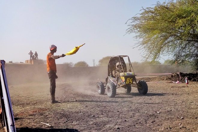A volunteer guiding a mBAJA 2018 participant towards the right path.