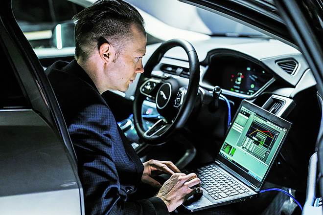 Iain Suffield, a Jaguar technical specialist, testing the I-PACE’s acoustic vehicle alert system inside the cockpit