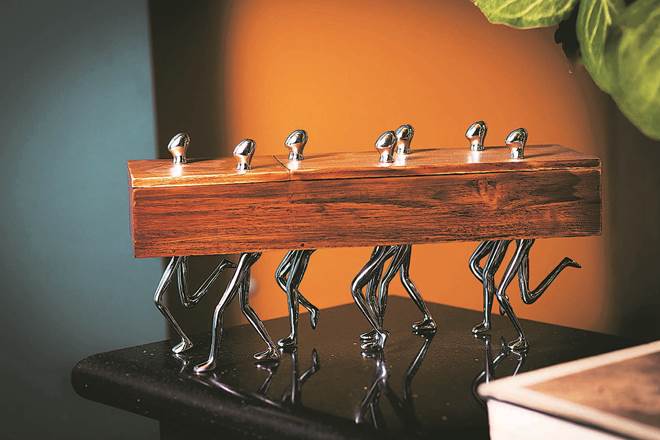 Seven Walkers by Mukul Goyal is a chromed brass and teakwood storage box with two compartments